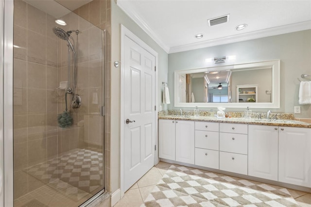 bathroom featuring visible vents, ornamental molding, a stall shower, and a sink