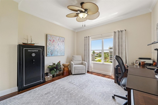 office space with baseboards, wood finished floors, a ceiling fan, and crown molding