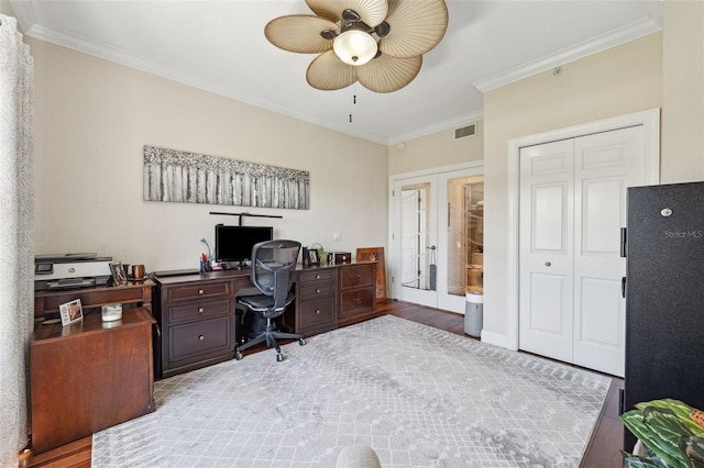 home office with wood finished floors, visible vents, a ceiling fan, french doors, and crown molding