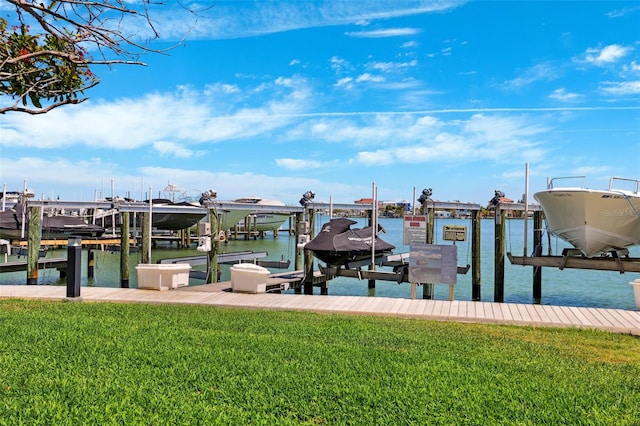 dock area featuring a yard, a water view, and boat lift