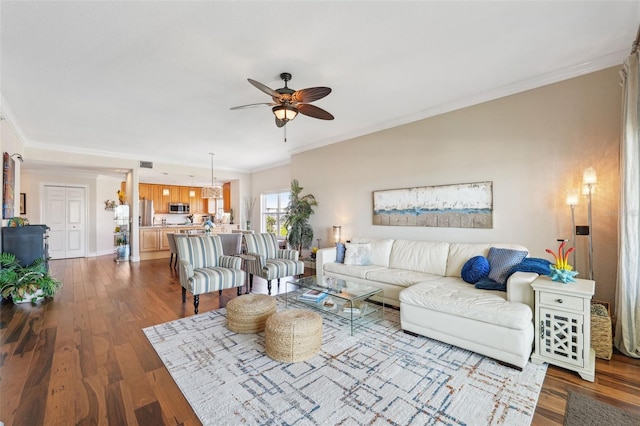 425 150th Ave Unit 2501, Madeira Beach, FL 33708 - living room featuring a ceiling fan, ornamental molding, and dark wood-type flooring