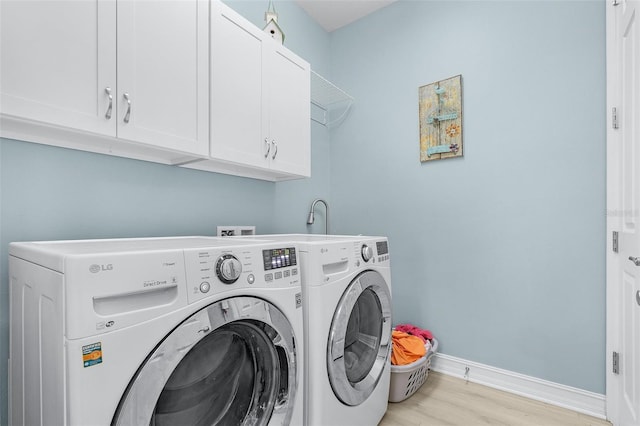 20605 Long Pond Rd, North Fort Myers, FL 33917 - laundry room featuring cabinet space, washer and clothes dryer, light wood finished floors, and baseboards