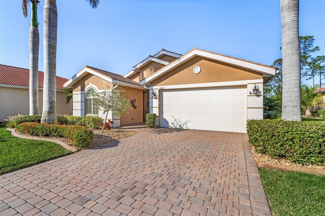 20605 Long Pond Rd, North Fort Myers, FL 33917 - view of front of home featuring stucco siding, decorative driveway, and an attached garage