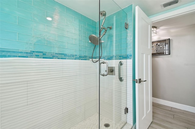 5200 Brittany Dr S Unit 1502, Saint Petersburg, FL 33715 - bathroom with a shower stall, wood finished floors, baseboards, and visible vents