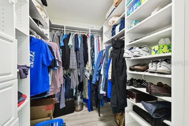 5200 Brittany Dr S Unit 1502, Saint Petersburg, FL 33715 - spacious closet featuring wood finished floors