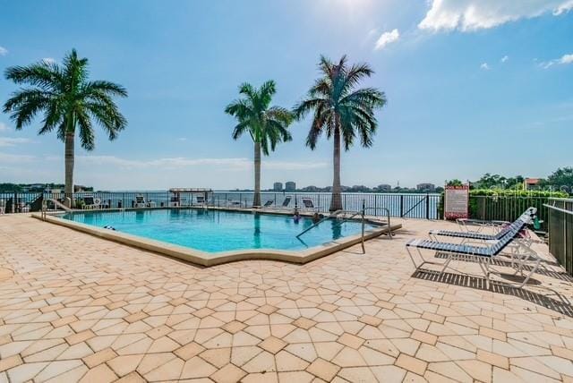 5200 Brittany Dr S Unit 1502, Saint Petersburg, FL 33715 - community pool featuring a patio area and fence