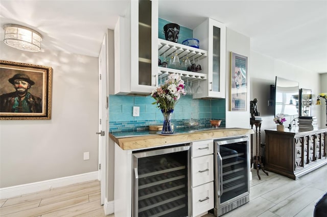 5200 Brittany Dr S Unit 1502, Saint Petersburg, FL 33715 - bar featuring indoor wet bar, backsplash, wood finish floors, and wine cooler