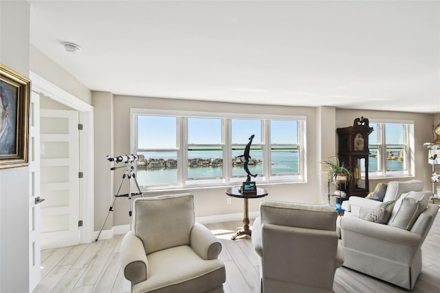 5200 Brittany Dr S Unit 1502, Saint Petersburg, FL 33715 - living area featuring a water view, baseboards, and light wood-style floors