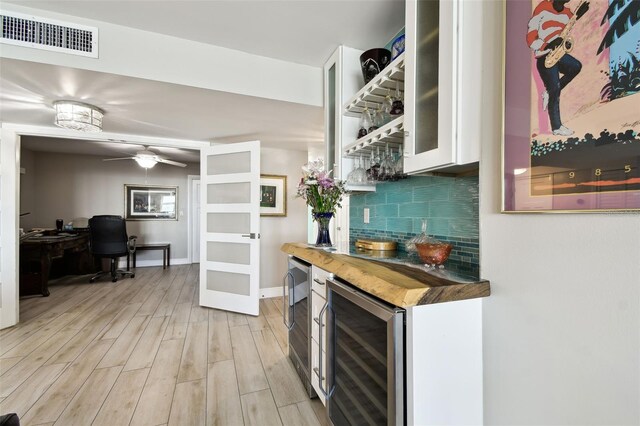 5200 Brittany Dr S Unit 1502, Saint Petersburg, FL 33715 - bar featuring light wood-style floors, a dry bar, visible vents, wine cooler, and decorative backsplash
