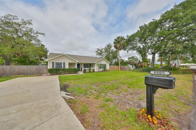 8805 Van Fleet Rd, Riverview, FL 33578 - ranch-style home with covered porch, fence, and a front lawn