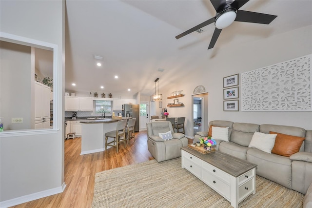 8805 Van Fleet Rd, Riverview, FL 33578 - living area with ceiling fan, visible vents, vaulted ceiling, recessed lighting, and light wood finished floors