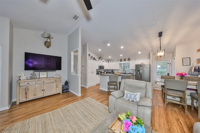 8805 Van Fleet Rd, Riverview, FL 33578 - living area with light wood-style floors, visible vents, and lofted ceiling