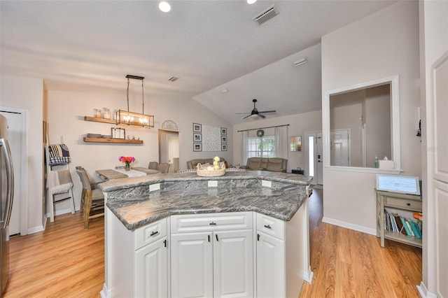 8805 Van Fleet Rd, Riverview, FL 33578 - kitchen with vaulted ceiling, open floor plan, a ceiling fan, white cabinets, and light wood-style floors