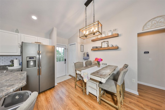 8805 Van Fleet Rd, Riverview, FL 33578 - dining room featuring light wood-style floors, vaulted ceiling, recessed lighting, baseboards, and a notable chandelier