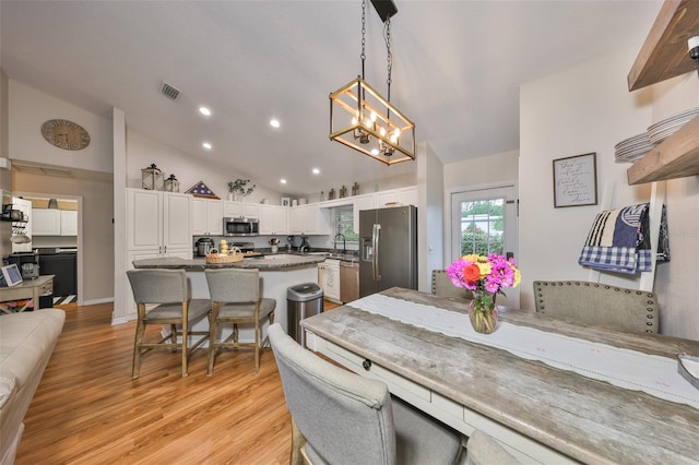 8805 Van Fleet Rd, Riverview, FL 33578 - dining space with visible vents, a chandelier, light wood-style floors, recessed lighting, and lofted ceiling
