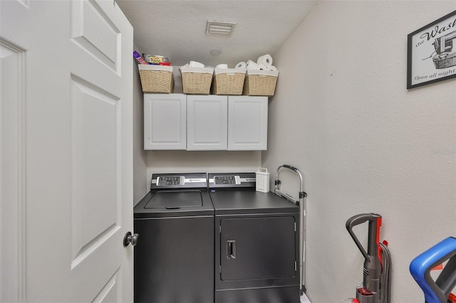 8805 Van Fleet Rd, Riverview, FL 33578 - washroom featuring separate washer and dryer, a textured ceiling, and cabinet space