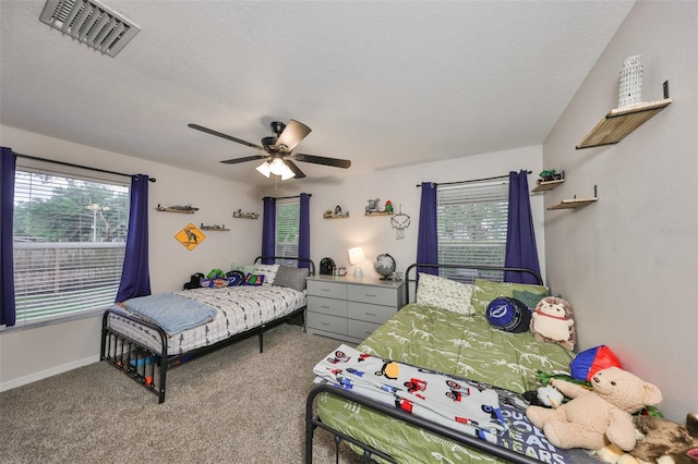 8805 Van Fleet Rd, Riverview, FL 33578 - carpeted bedroom featuring a ceiling fan, visible vents, multiple windows, and a textured ceiling