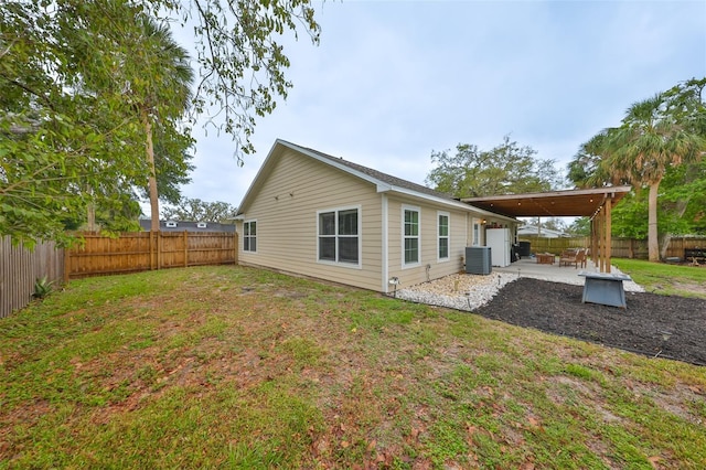 8805 Van Fleet Rd, Riverview, FL 33578 - back of property featuring a patio, central AC unit, a fenced backyard, and a yard
