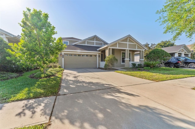 craftsman inspired home with a porch, an attached garage, stucco siding, a front lawn, and driveway