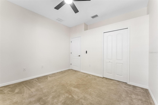 unfurnished bedroom featuring baseboards, visible vents, and carpet floors