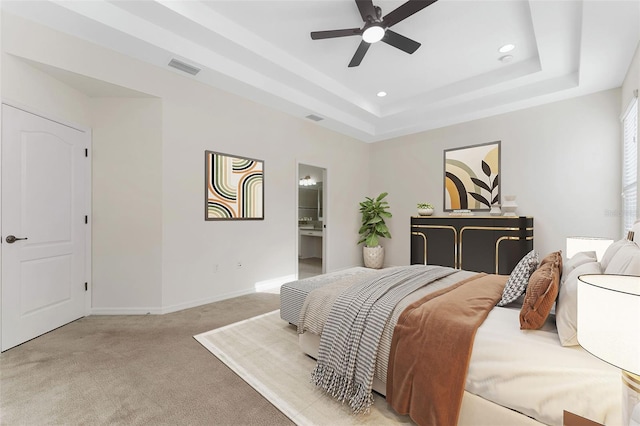 bedroom with baseboards, recessed lighting, carpet floors, visible vents, and a raised ceiling