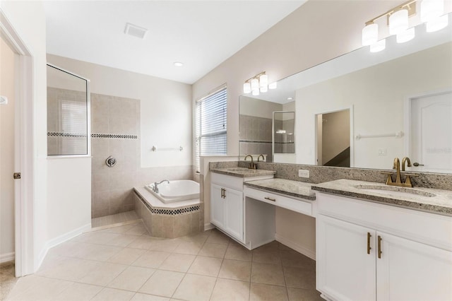 full bathroom featuring a walk in shower, tile patterned floors, a garden tub, and a sink