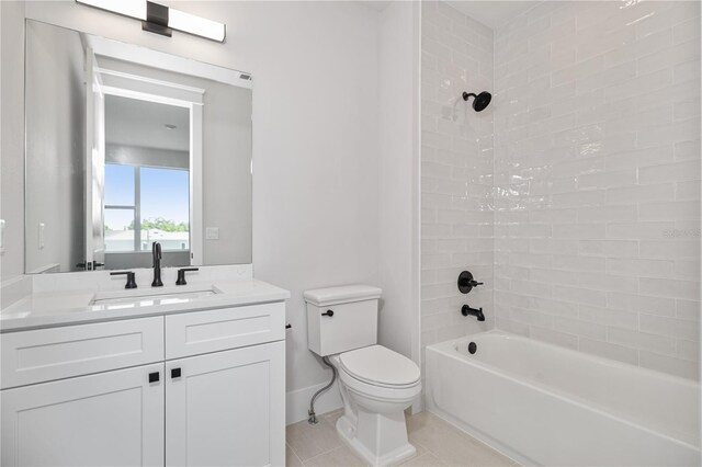 11 29th St N, Saint Petersburg, FL 33713 - bathroom with toilet, vanity, tile patterned flooring, and washtub / shower combination