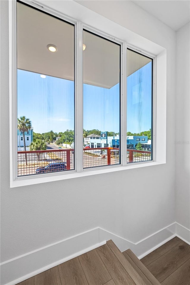 11 29th St N, Saint Petersburg, FL 33713 - staircase featuring baseboards, wood finished floors, and a healthy amount of sunlight