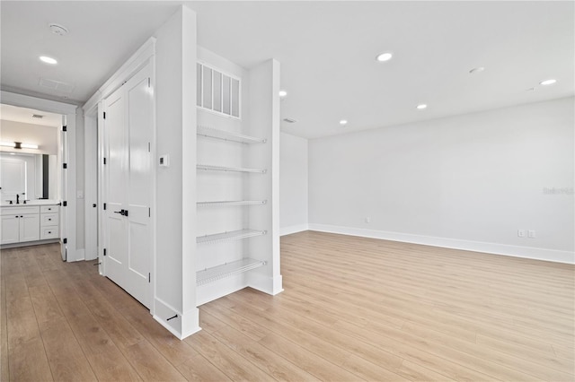 11 29th St N, Saint Petersburg, FL 33713 - corridor with light wood-style flooring, visible vents, recessed lighting, a sink, and baseboards