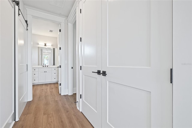 11 29th St N, Saint Petersburg, FL 33713 - hall featuring a barn door, visible vents, and light wood-style flooring