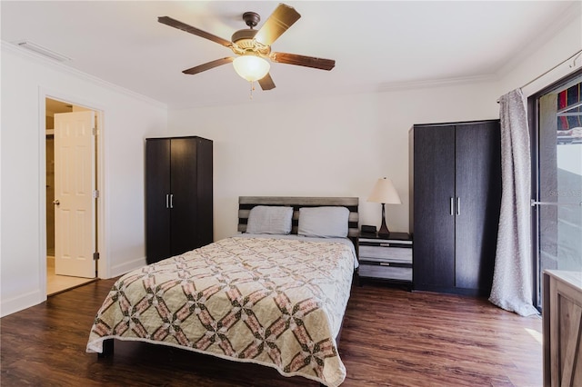 bedroom featuring visible vents, baseboards, wood finished floors, ceiling fan, and ornamental molding