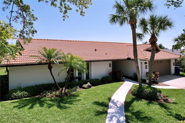 view of front of house featuring a tile roof, stucco siding, and an attached garage