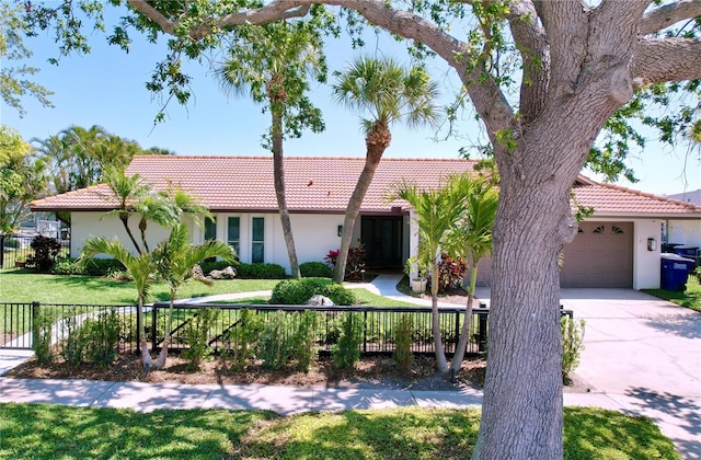 773 Snug Is, Clearwater Beach, FL 33767 - view of front of house with stucco siding, a tile roof, and an attached garage