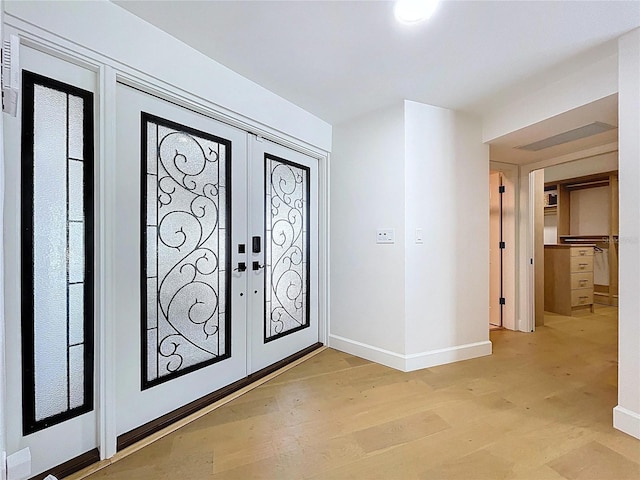 773 Snug Is, Clearwater Beach, FL 33767 - entryway with french doors, baseboards, and light wood-type flooring
