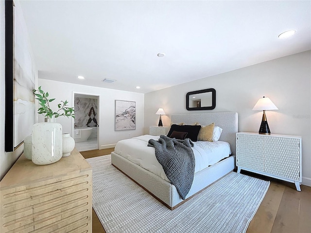 773 Snug Is, Clearwater Beach, FL 33767 - bedroom featuring wood finished floors, recessed lighting, baseboards, and connected bathroom