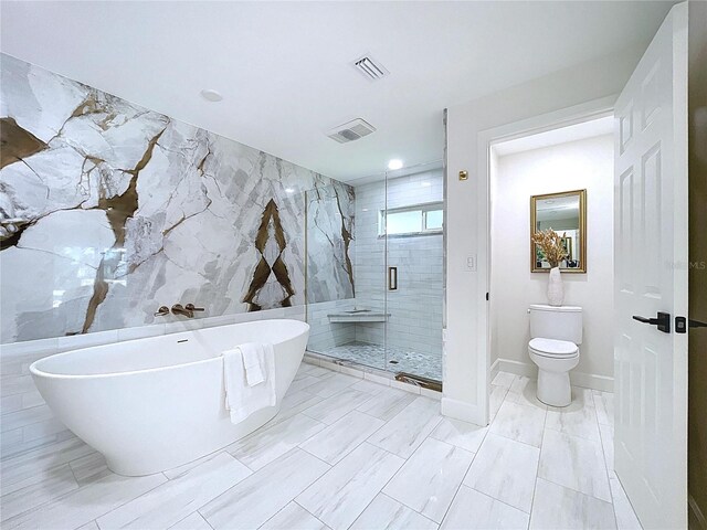 773 Snug Is, Clearwater Beach, FL 33767 - full bath featuring a shower stall, a freestanding bath, toilet, and tile walls