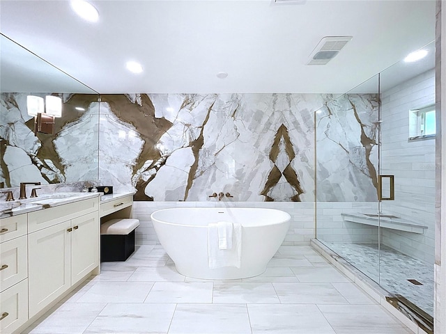 773 Snug Is, Clearwater Beach, FL 33767 - bathroom featuring tile walls, a shower stall, a freestanding bath, vanity, and recessed lighting