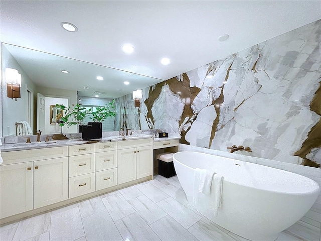 773 Snug Is, Clearwater Beach, FL 33767 - full bathroom with double vanity, recessed lighting, tile walls, and a freestanding bath