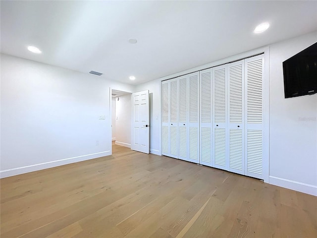 773 Snug Is, Clearwater Beach, FL 33767 - unfurnished bedroom with baseboards, light wood-style floors, recessed lighting, and a closet