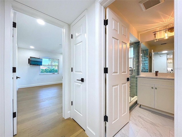 773 Snug Is, Clearwater Beach, FL 33767 - hallway with a sink and baseboards