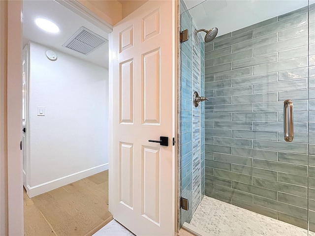 773 Snug Is, Clearwater Beach, FL 33767 - bathroom with a stall shower, baseboards, and wood finished floors