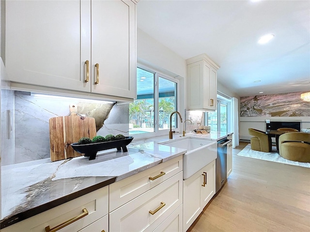 773 Snug Is, Clearwater Beach, FL 33767 - kitchen with a sink, light stone countertops, light wood-type flooring, healthy amount of natural light, and recessed lighting