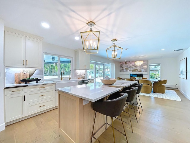 773 Snug Is, Clearwater Beach, FL 33767 - kitchen with a sink, a kitchen island, plenty of natural light, light wood-style floors, and recessed lighting