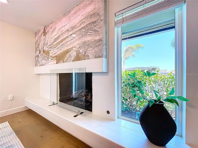 773 Snug Is, Clearwater Beach, FL 33767 - detailed view of wood finished floors, a multi sided fireplace, and baseboards