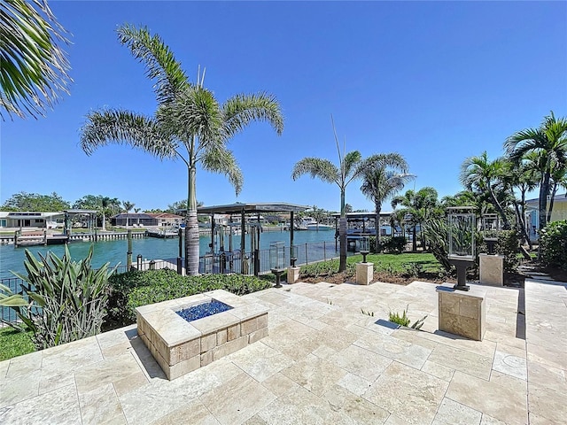 773 Snug Is, Clearwater Beach, FL 33767 - view of patio featuring an outdoor fire pit, boat lift, a boat dock, and a water view