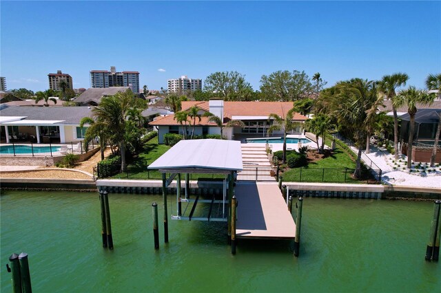773 Snug Is, Clearwater Beach, FL 33767 - dock area featuring boat lift, a fenced backyard, and a water view