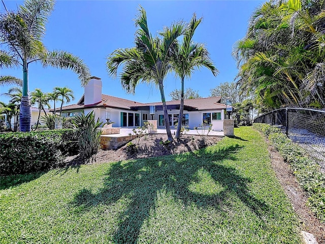 773 Snug Is, Clearwater Beach, FL 33767 - back of house featuring stucco siding and a chimney