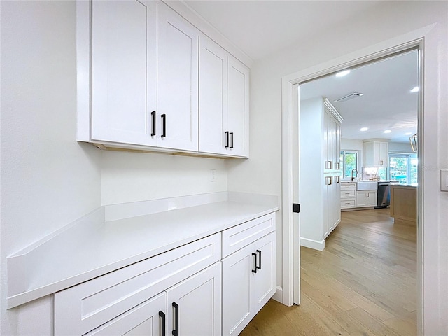 773 Snug Is, Clearwater Beach, FL 33767 - hall with light wood finished floors, recessed lighting, and a sink