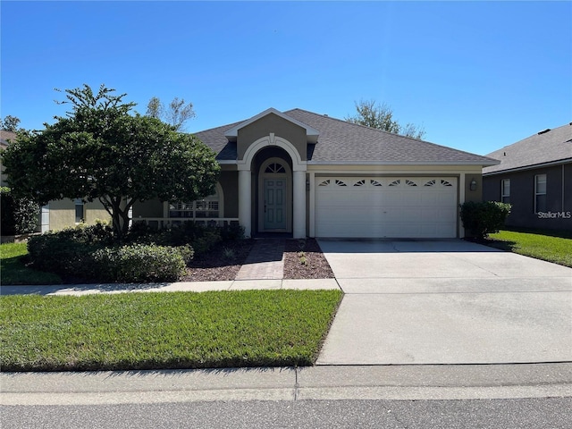 ranch-style house with a shingled roof, a front lawn, a garage, stucco siding, and driveway