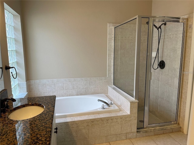 bathroom featuring tile patterned floors, a shower stall, a wealth of natural light, and a bath
